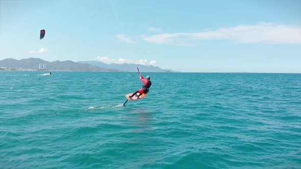 Aerial View of the City Beach and Active People Practicing Kite Surfing and Windsurfing. Kitesurfing