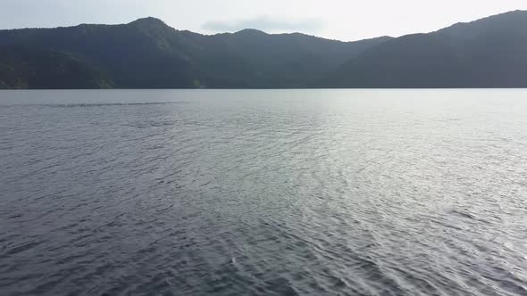 Close flight over the water on lake ashi in hakone