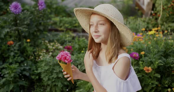 Smiling Teen Girl Holding Waffle Cone with Flowers in Garden