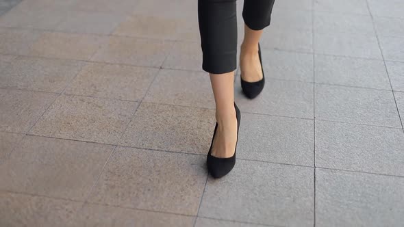 Business woman legs in high-heeled shoes walking