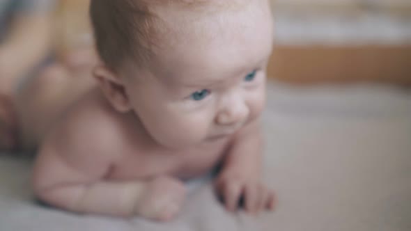 Adorable Infant Boy Lies on Stomach and Enjoys Massage