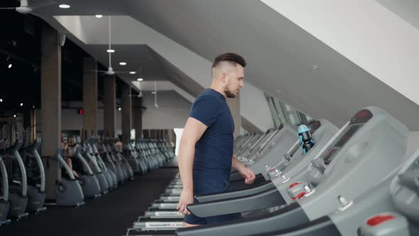 Young Man in Sportswear Running on Treadmill at Gym Start Prepare Training Workout