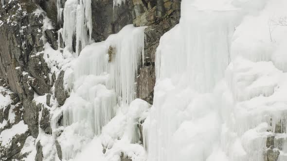 Scenic aerial frozen sheer cliff face Mount Kineo, Maineline