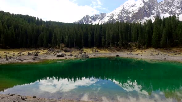 Stunning turquoise lake Carezza in the Alps at sunrise in spring, Italy