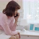 Young woman talking mobile phone and crying in bedroom - VideoHive Item for Sale