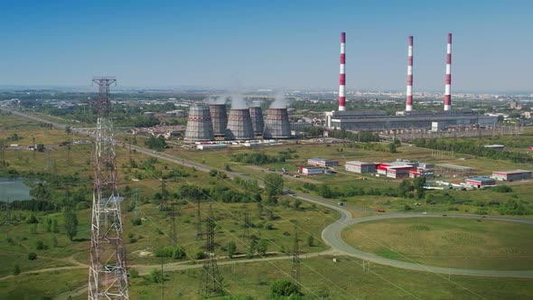 Aerial Drone View Electric Power Lines with a Coalfired Thermal Power Plant in the Background