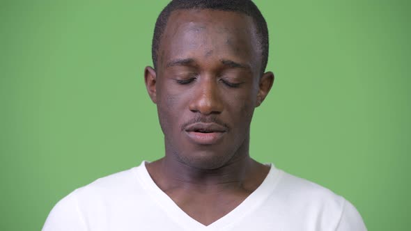 Young African Man Nodding No Against Green Background