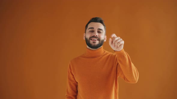 Portrait of Handsome Young Hipster Showing Call Me Gesture and Smiling