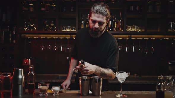 Experienced Bartender Pours Liquid Using Jigger Into Shaker