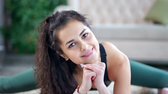 Closeup Portrait of Beautiful Young Caucasian Fitness Girl Sitting in Twine Looking at Camera