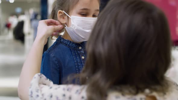 Video of mother putting on a protective mask for her daughter. Shot with RED helium camera in 8K.