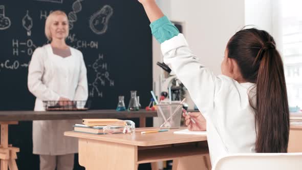 Slowmo of Woman Teaching Chemistry to Kids