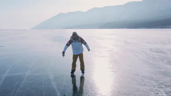 Aerial View of Man Skating on Lake Baikal Covered By Ice