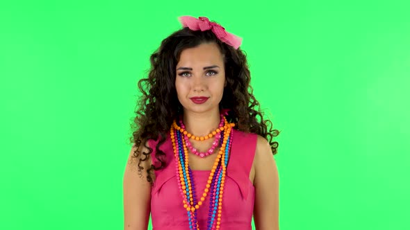 Young Woman Standing, Spreads Out in a Smile and Looks at the Camera. Green Screen