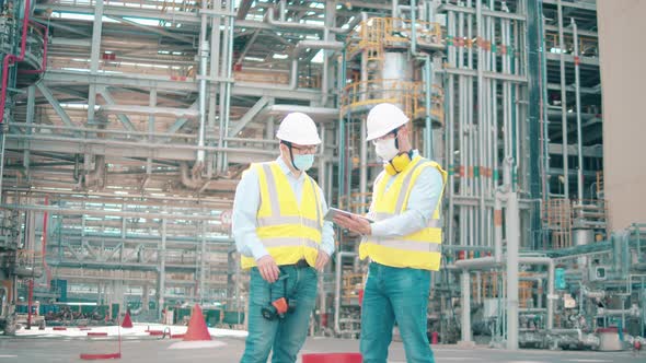 Oil Refinery Workers are Discussing a Project