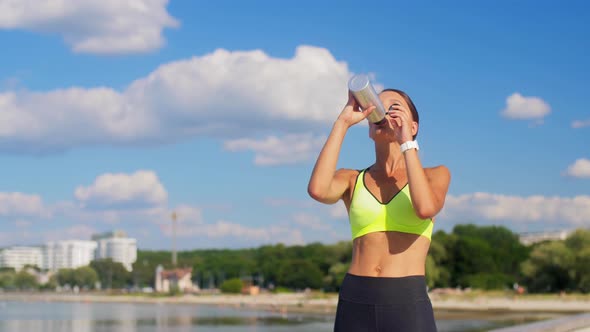 Woman Running and Drinking Water From Bottle