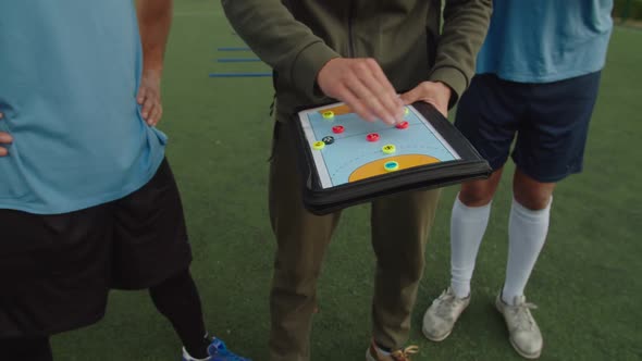 Soccer Coach Giving Personal Instructions to Each Sportsman Outdoors