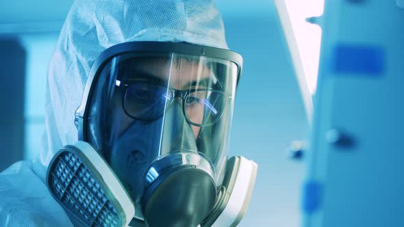 Male Specialist is Wearing a Hazmat Mask in the Laboratory