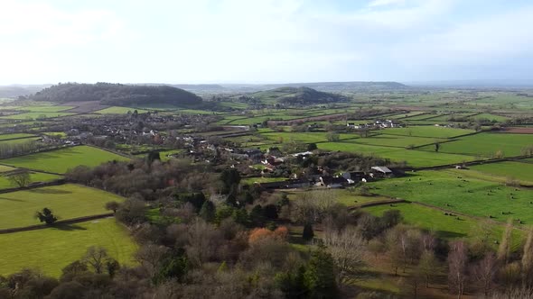 The small, quaint rural village of Compton Dundon countryside with green fields, farms and farmland