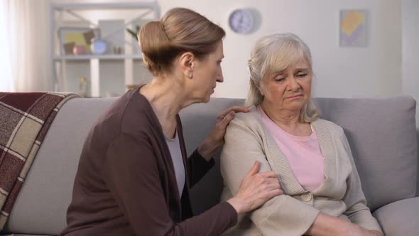 Mature Woman Supporting and Comforting Her Elderly Friend, Health Problems, Loss