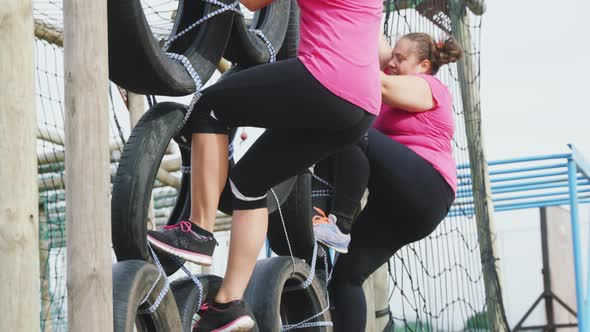 Female friends enjoying exercising at boot camp together