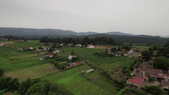 Flying Over Green Countryside at Cloudy Day