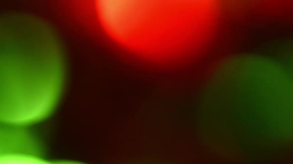 Christmas Bokeh Lights Flash on and Off Against a Dark Background