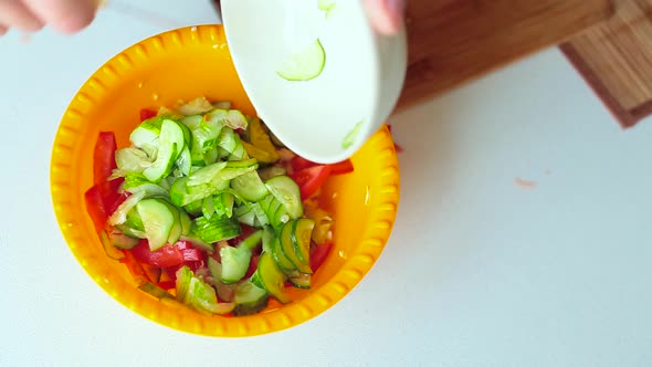 Male Hands Mix Cucumber and Tomato Salad