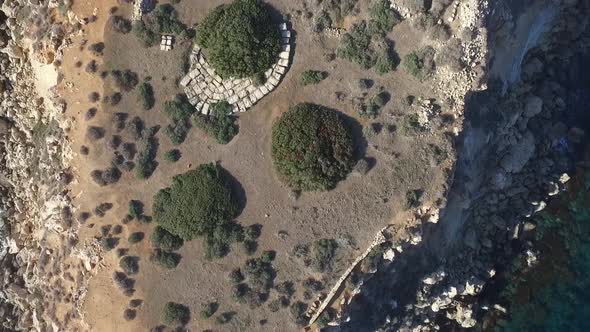 Low drone shot flying close over the ruins of the uninhabited island of Yeronisos Sacred Holy Island