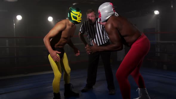 Masked wrestlers prepare to fight