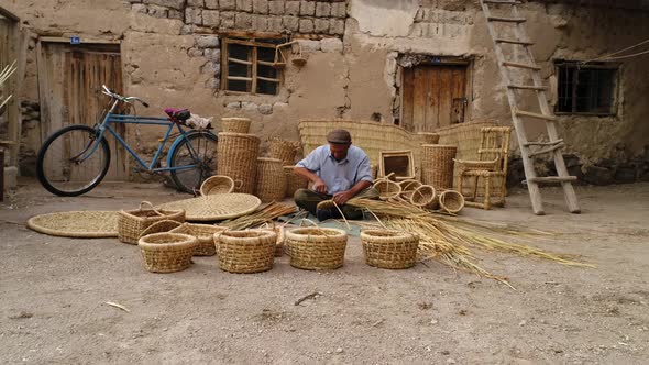 Old Man Making A Bamboo Basket