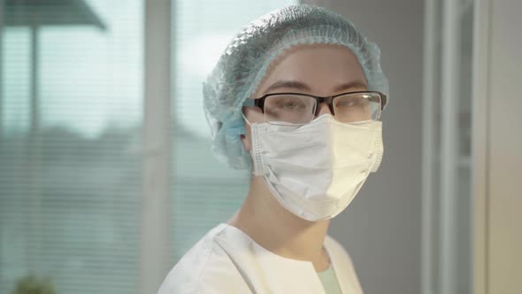 Female Doctor In Laboratory With Microscope And Chemical Test Tubes