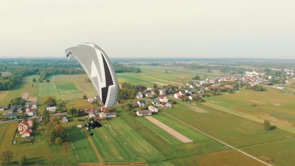 Aerial Drone View Of Paramotor Tandem Having Fun Gliding And Flying In The Air