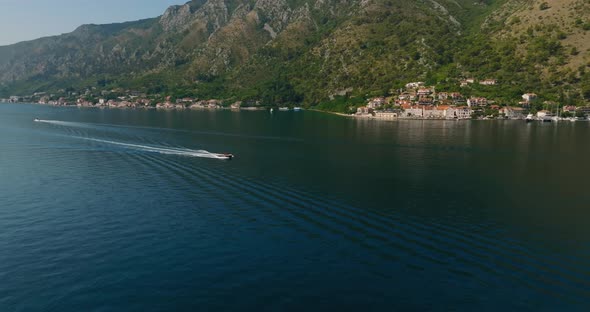 speeding boat in kotor bay, blue sea water