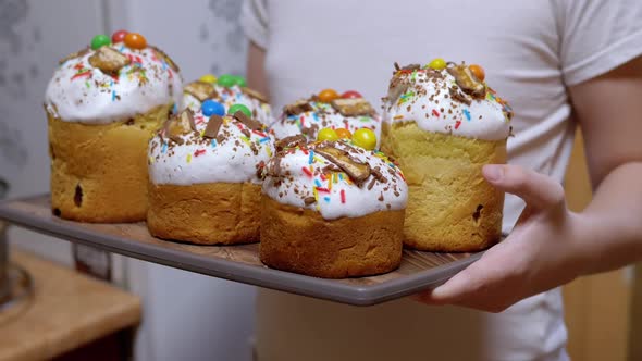 Child Holding Many Easter Cakes on a Tray Standing in the Kitchen