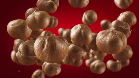 Flying of Hazelnuts in Deep Red Background