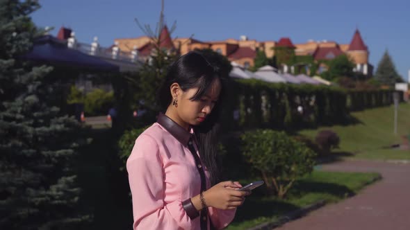 Girl Sharing in Social Net on Telephone Outdoors