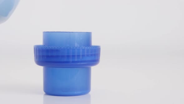 Fabric softener dosing in container cap 4K footage