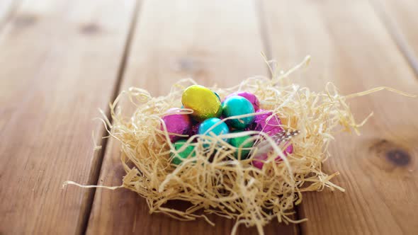 Chocolate Easter Eggs in Straw Nest on Table