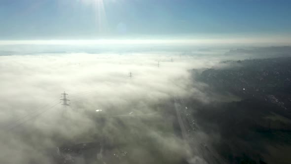 Aerial view of fog in the countryside covering a motorway