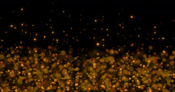 Animation of multiple glowing gold spots of light moving in hypnotic motion on black background alt