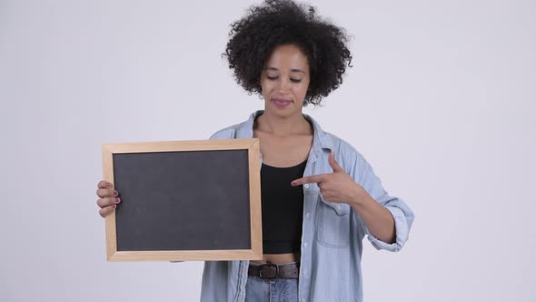 Young Happy African Woman Holding Blackboard and Giving Thumbs Up