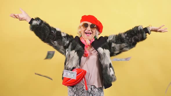 Rich Elegant Woman in Fur Coat and Red Cap Throwing Money