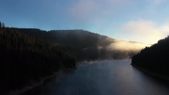 Aerial View of a Misty Lake. Dawn Dark Lights During Sunrise, Cold Weather