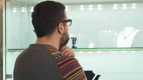 Bearded Mature Man Choosing Jewelry Present at the Shopping Mall