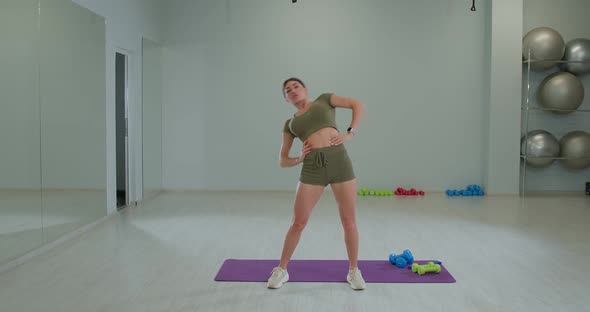 Athletic Brunette Girl Performs Torso Rotation