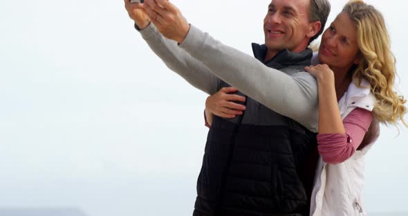 Mature couple taking a selfie from digital tablet