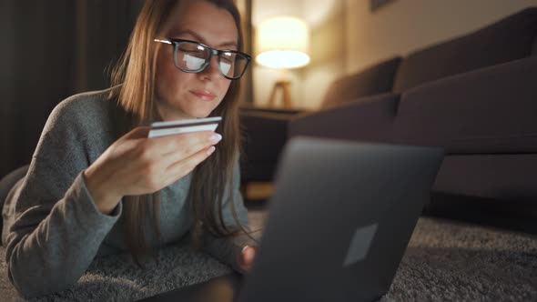Woman Glasses Is Lying Floor Makes Online Purchase Using Credit Card Laptop Evening
