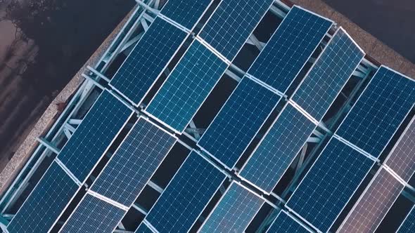 Top view of innovative solar panel collections on roof. Blue photovoltaic panels to get clean ecolog