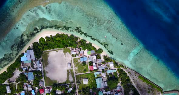 Luxury flying island view of a white sandy paradise beach and blue water background in colourful 4K